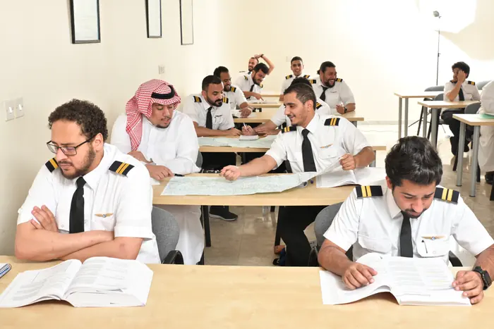 A class working on charts with their instructor
