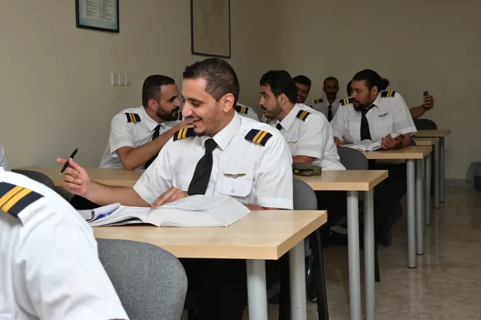Trainees discussing coursework during a class session