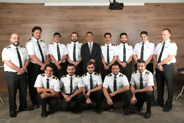 A cohort with the academy team in the training hall