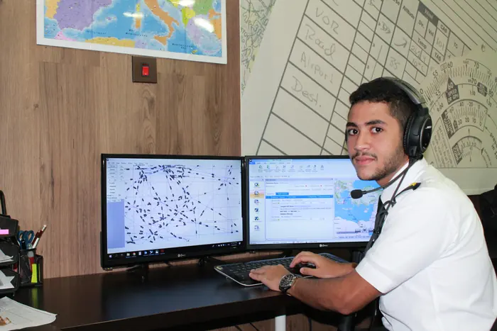 A trainee working the flight dispatcher console