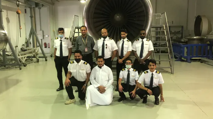 Trainees on a visit to an engine maintenance hall