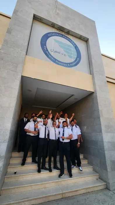 Graduates celebrating on the academy steps