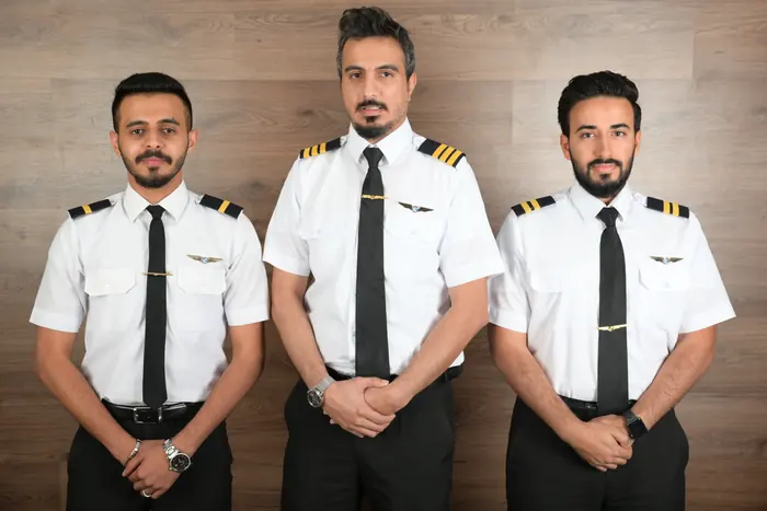 Three trainees in academy uniform